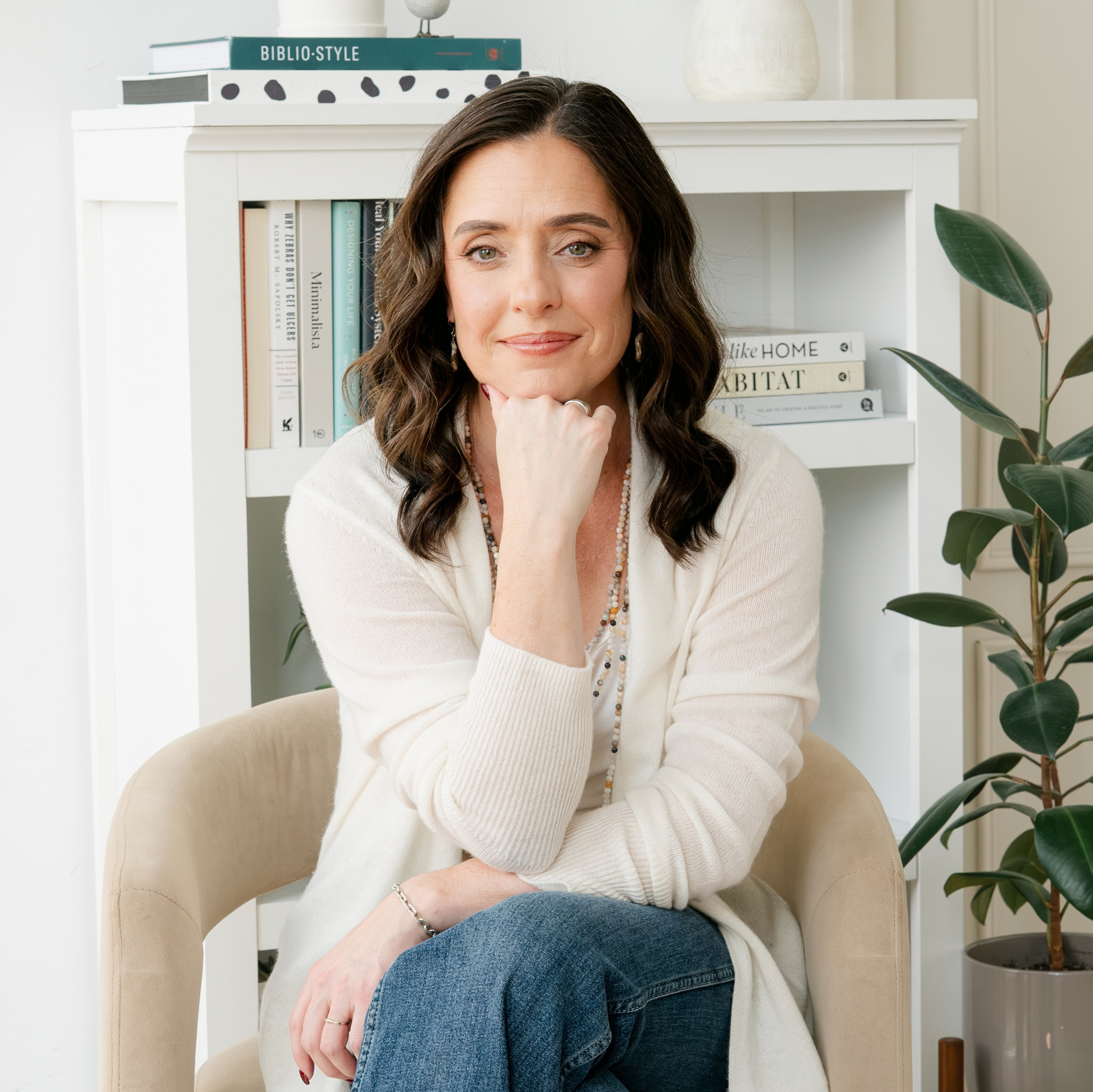 Christine Walker sitting in front of a bookshelf